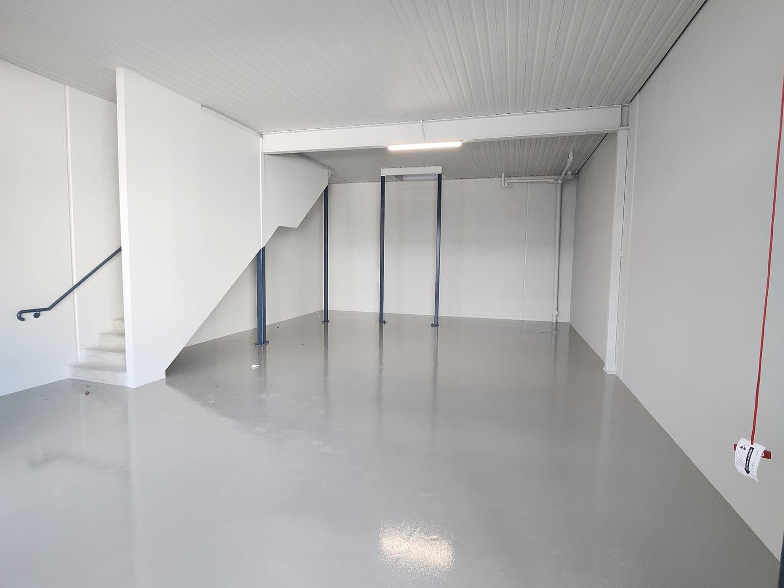 Grey flake epoxy floor beside a raised platform